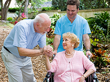 Male caregiver and couple holding hands